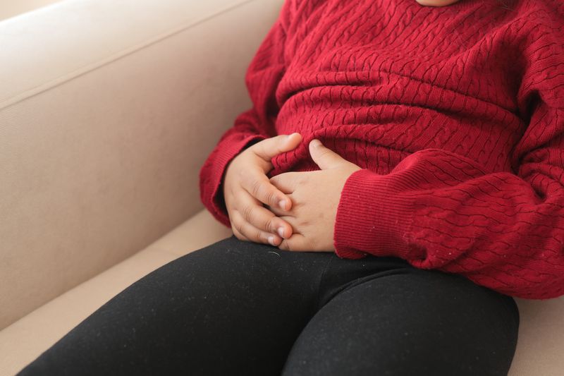 child suffering stomach pain close up