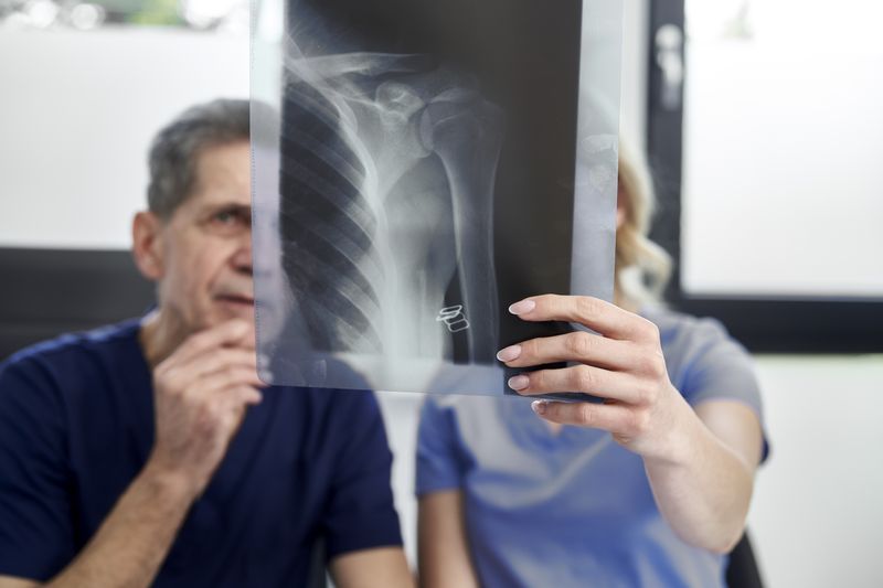doctor and patient examine a shoulder x ray