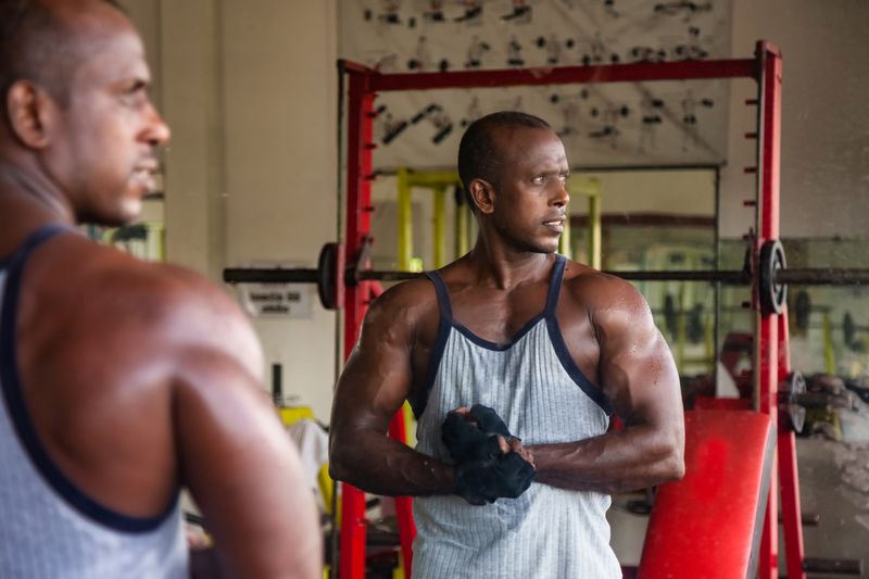 portrait bodybuilder man looking away at mirror at