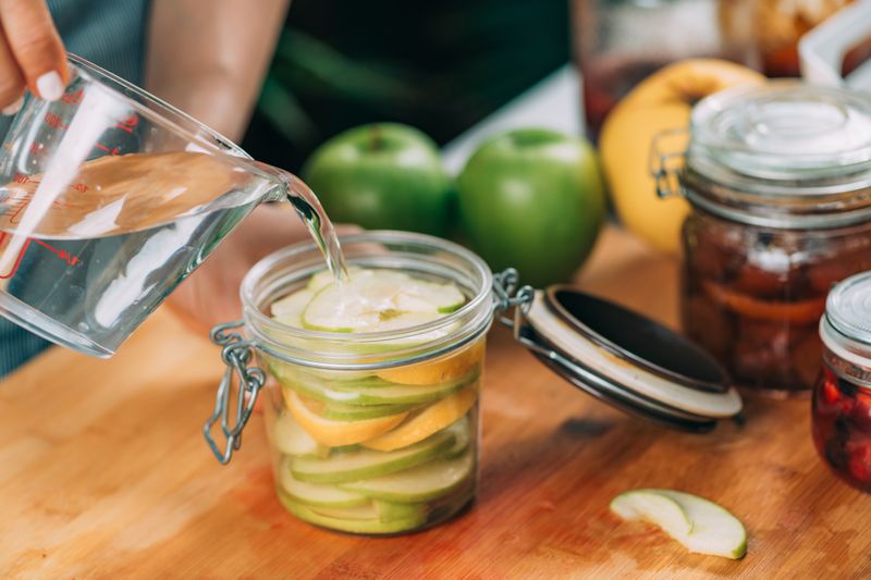 preparing apple infused water with fresh ingredien