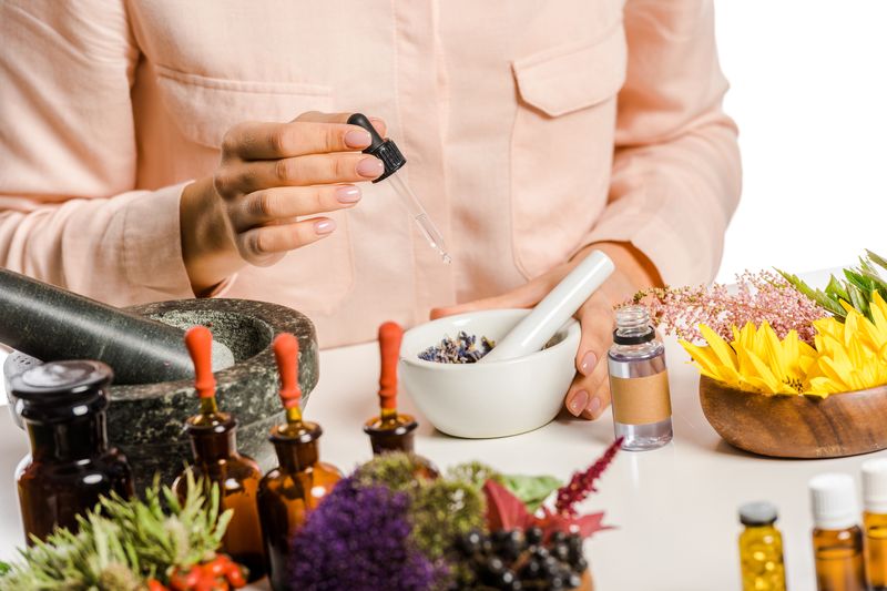 woman preparing alternative medicine in a home set
