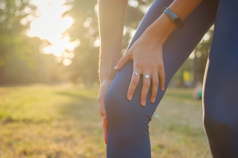 woman with knee pain in park