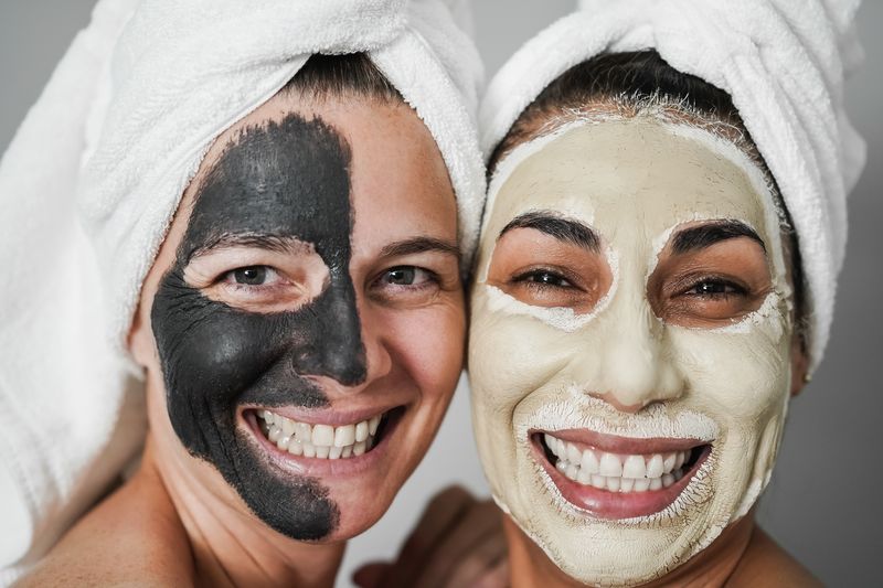 women enjoying facial masks with white towels